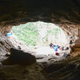 The entranceway of Baishiya Karst Cave, featuring various Buddhist ornamentations and sacraments.